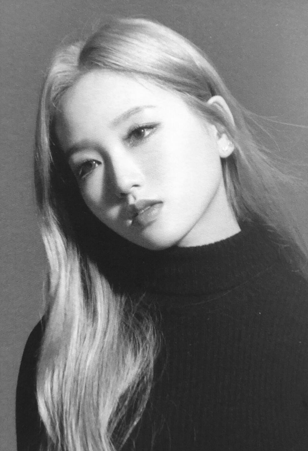 dramatic monochrome photo of gowon from loona - blonde and stunning in a black turtleneck, looking wistful